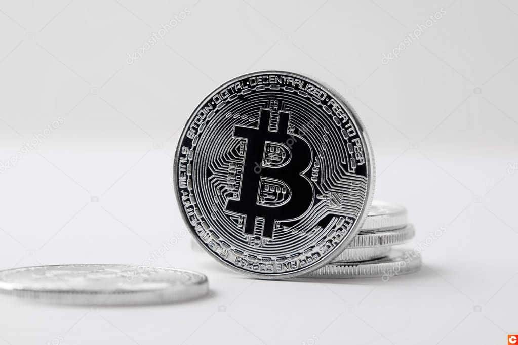 close-up shot of bitcoin standing on white surface