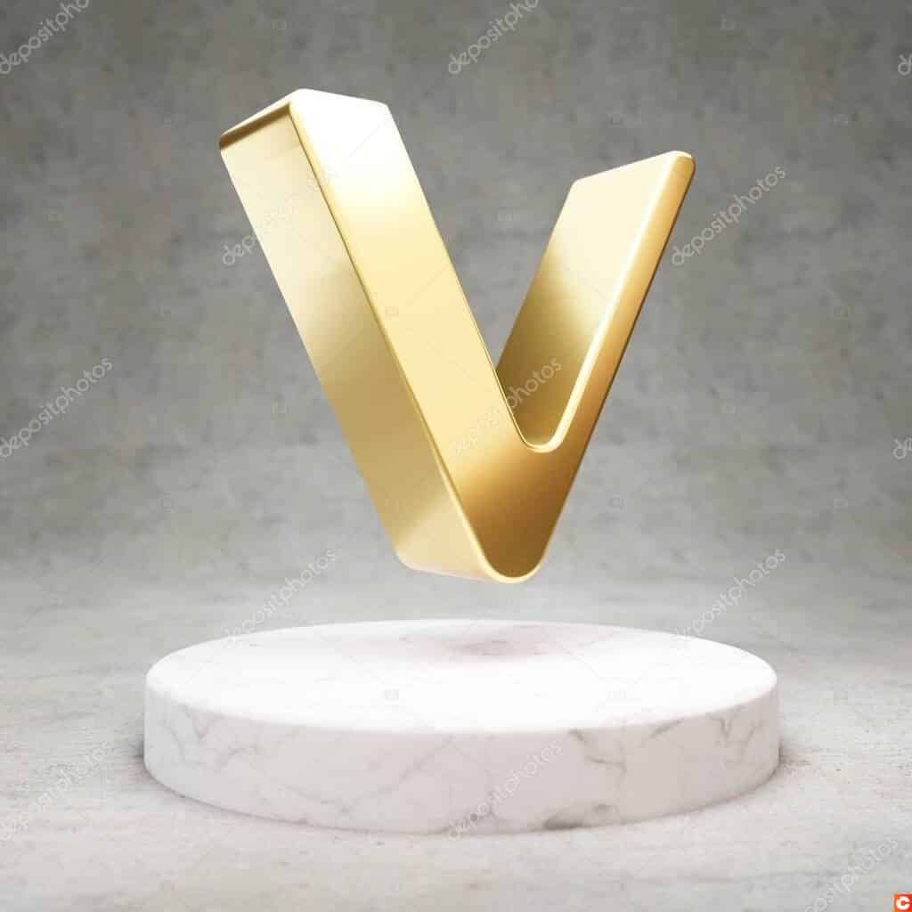 VeChain cryptocurrency icon. Gold 3d rendered VeChain symbol on white marble podium.