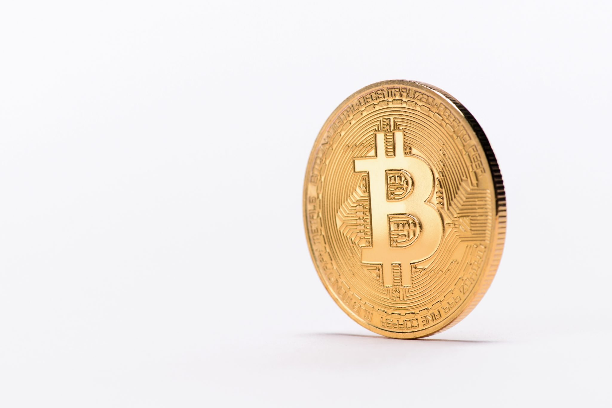 Close up view of golden bitcoin isolated on white
