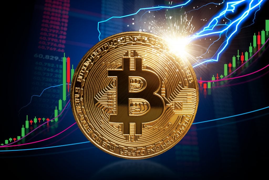 To the moon and Bitcoin stock growth concept: Strong increase of Bitcoin prices shown at candlestick bull market chart. Lightning hitting the bitcoin. Investment in cryptocurrency world.