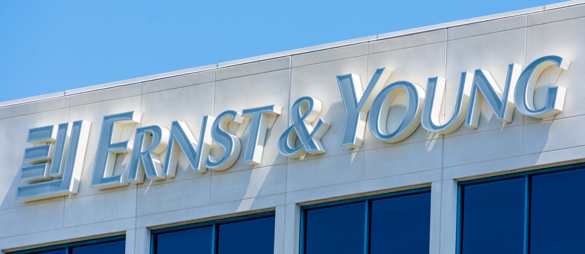 Ernst and Young logo atop of a multinational professional services firm office in Silicon Valley, high-tech hub of San Francisco Bay Area - Redwood City, California, USA - 2019