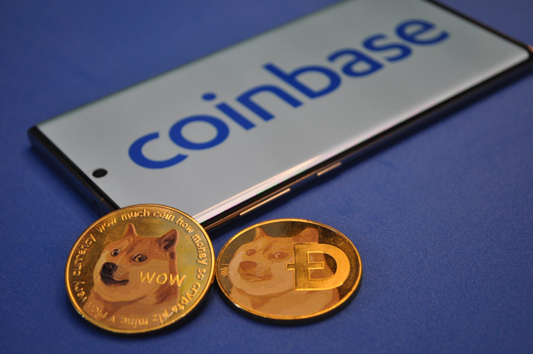 Kuching, Sarawak Malaysia - June 2, 2021: Macro view of gold color shiny coins with Dogecoin symbol and Coinbase background