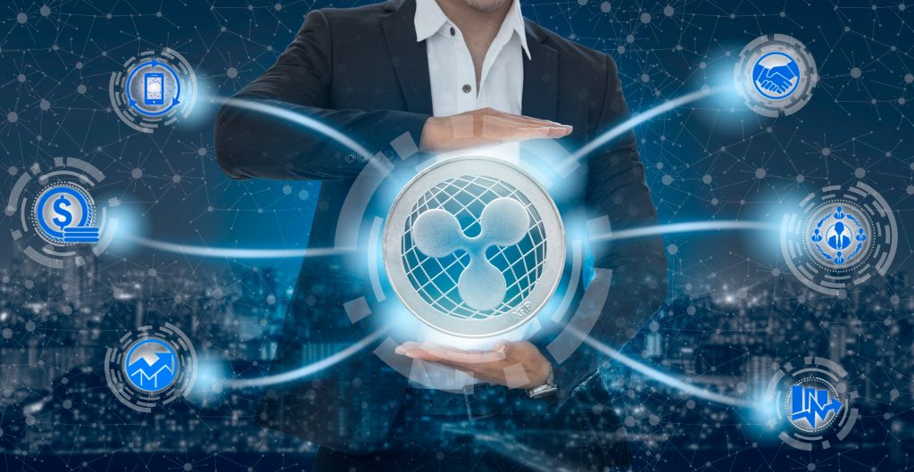 Ripple and cryptocurrency investing concept - Businessman holding Ripple (XRP) with mobile application business icons showing exchanging, trading, transfer and investment of blockchain technology.