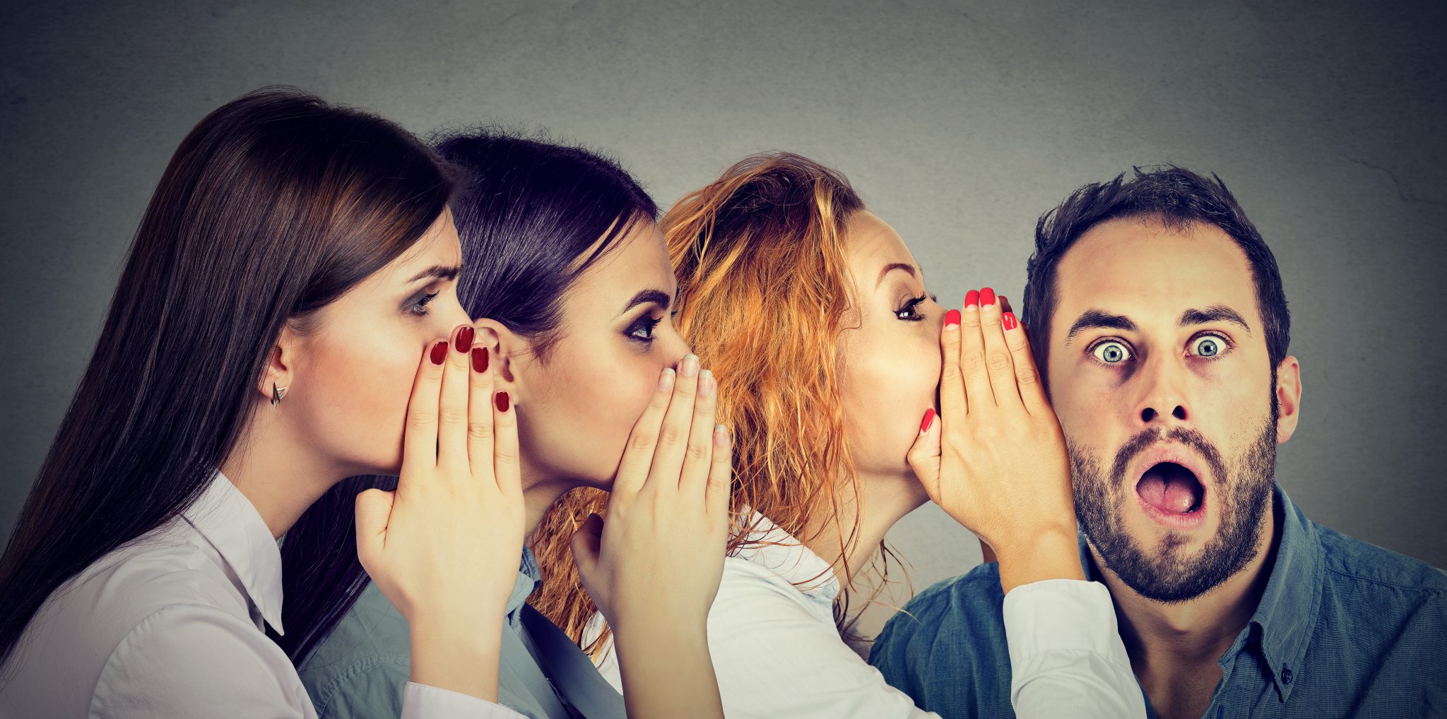 women whispering each other and to the shocked astonished man in the ear