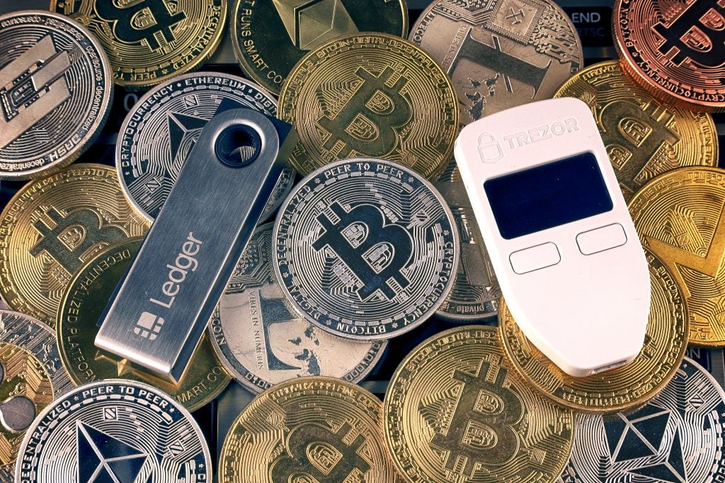 WROCLAW, POLAND - Jan 28, 2020: The physical version of Bitcoin (BTC), Trezor, Ledger (crypto hardware wallets) and other cryptocurrency backends.