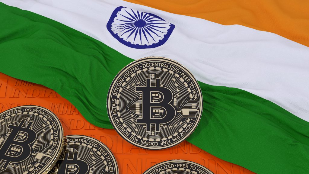 3d rendering of a metallic Bitcoin over an indian flag