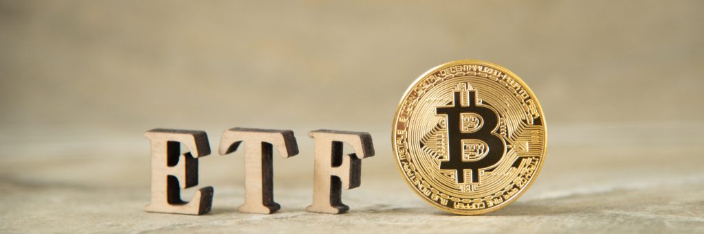 Bitcoin coin with ETF text on stone background