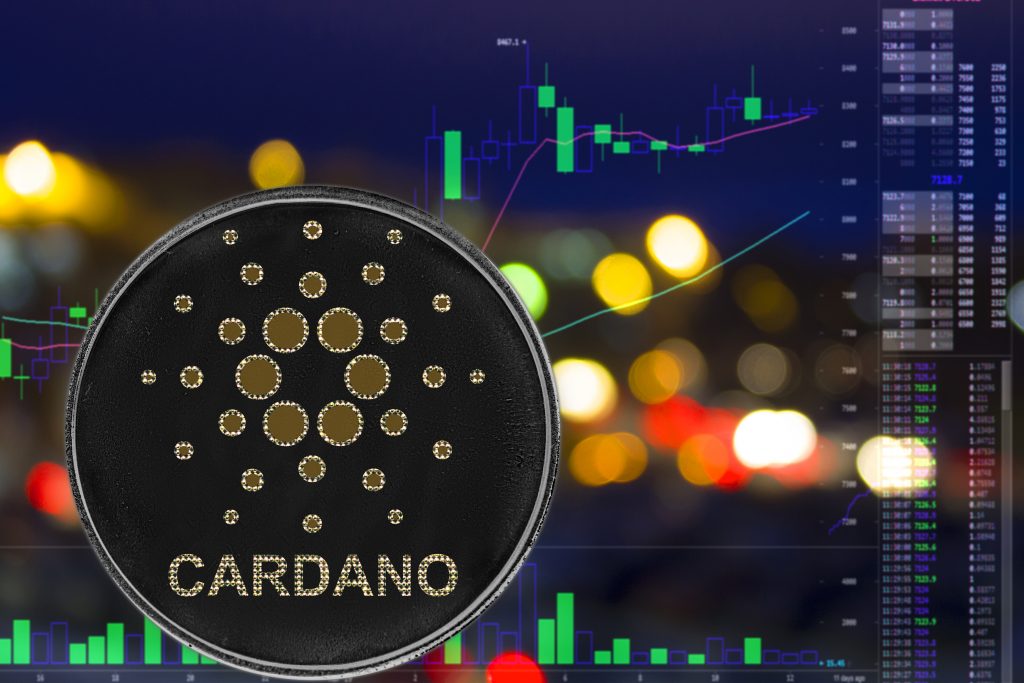 Coin cryptocurrency Cardano ADA on night city background and chart.