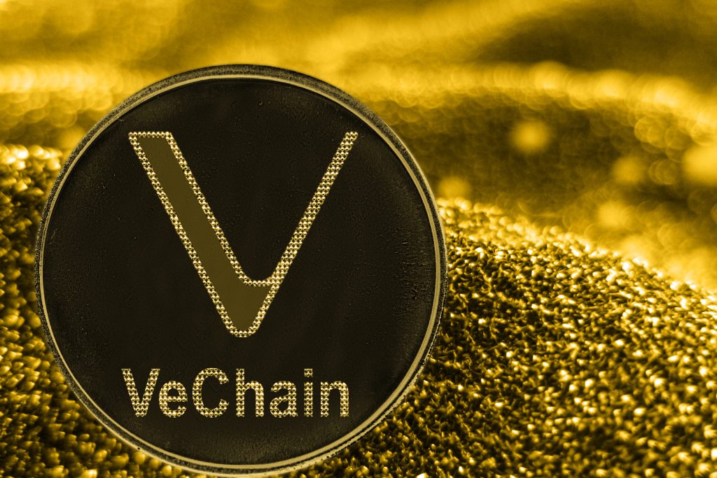 Coin cryptocurrency VeChain VET on golden background.