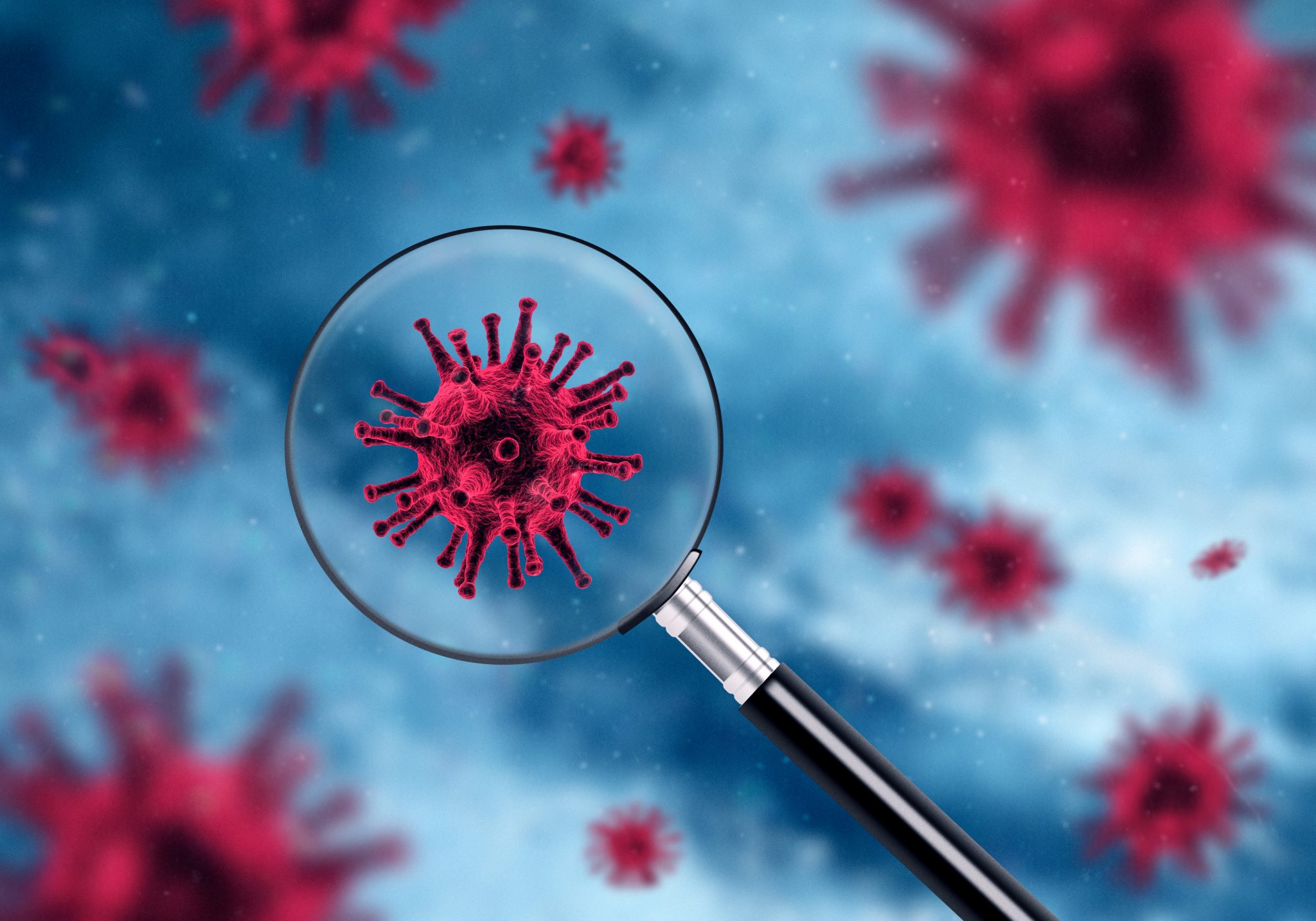 Healthcare concept with magnifying glass showing red virus bacteria