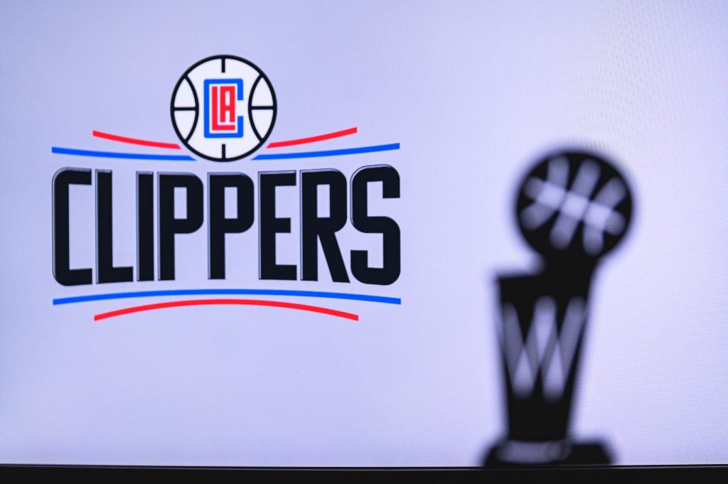 NEW YORK, USA, JUN 18, 2020: Los Angeles Clippers Basketball club on the white screen. Silhouette of NBA trophy in foreground.