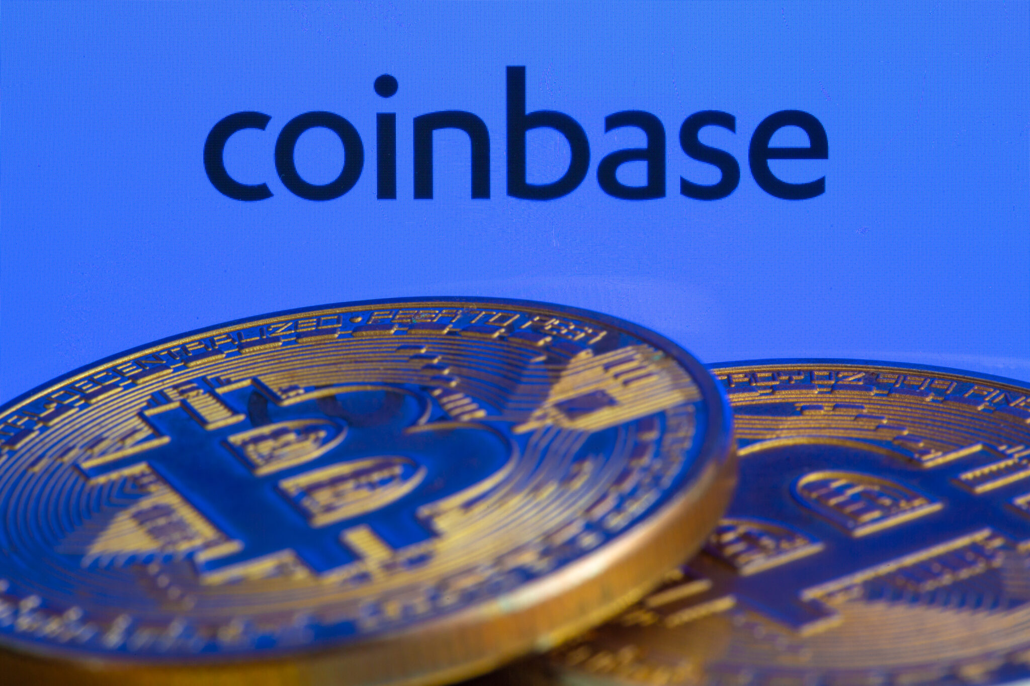 Coinbase logo and Bitcoins