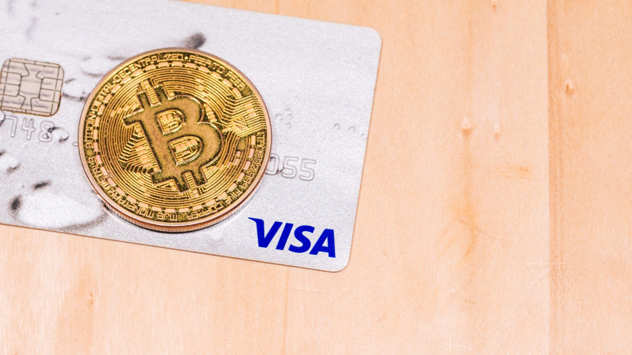 Bitcoin coin and Visa credit card