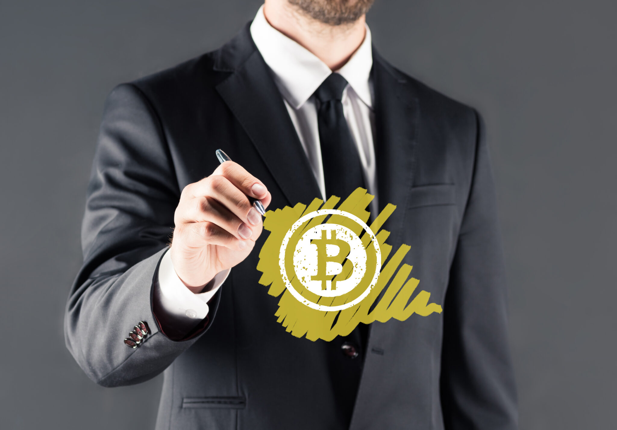 businessman drawing bitcoin sign