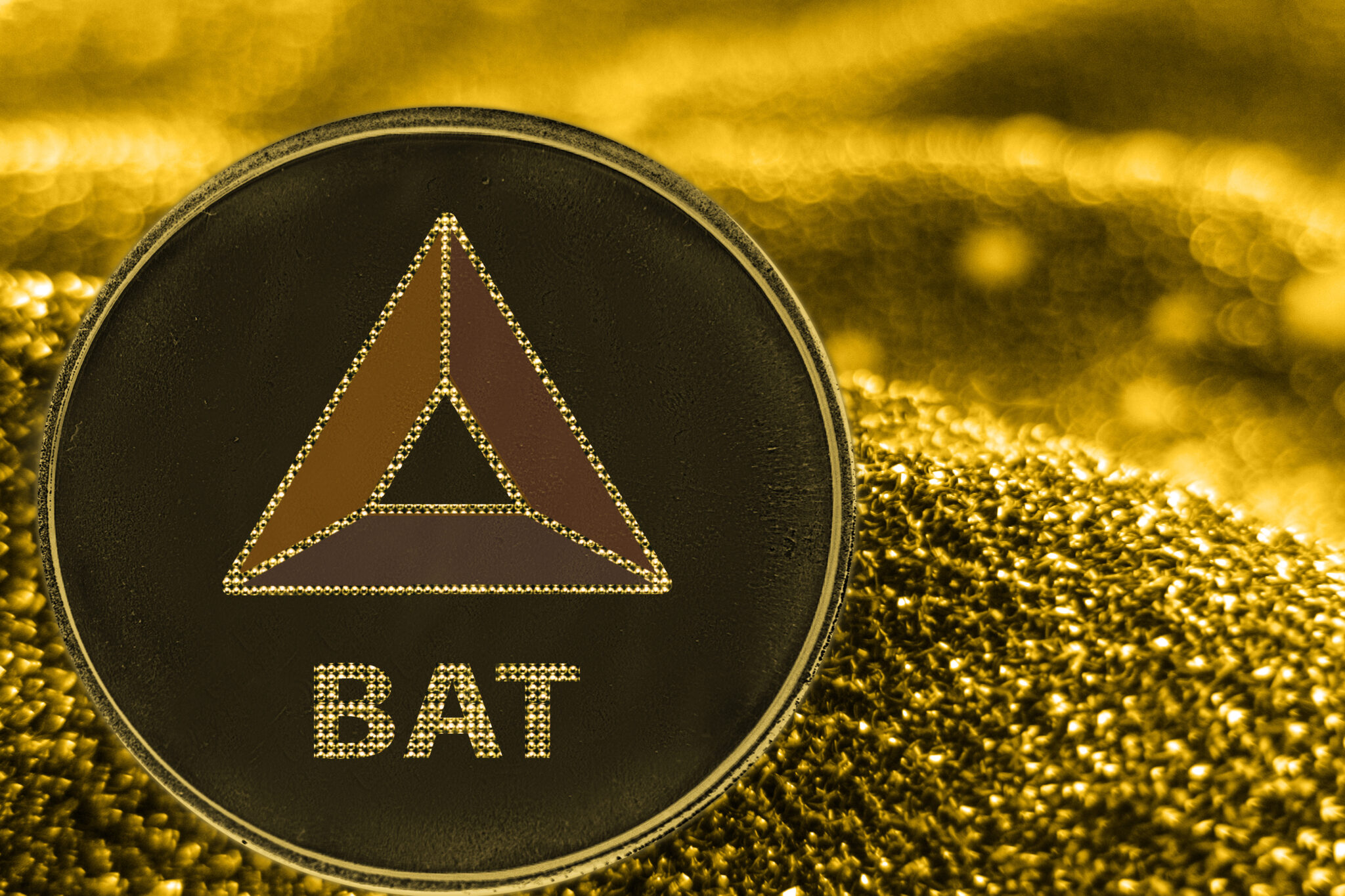 Coin cryptocurrency BAT cahs token on golden background.