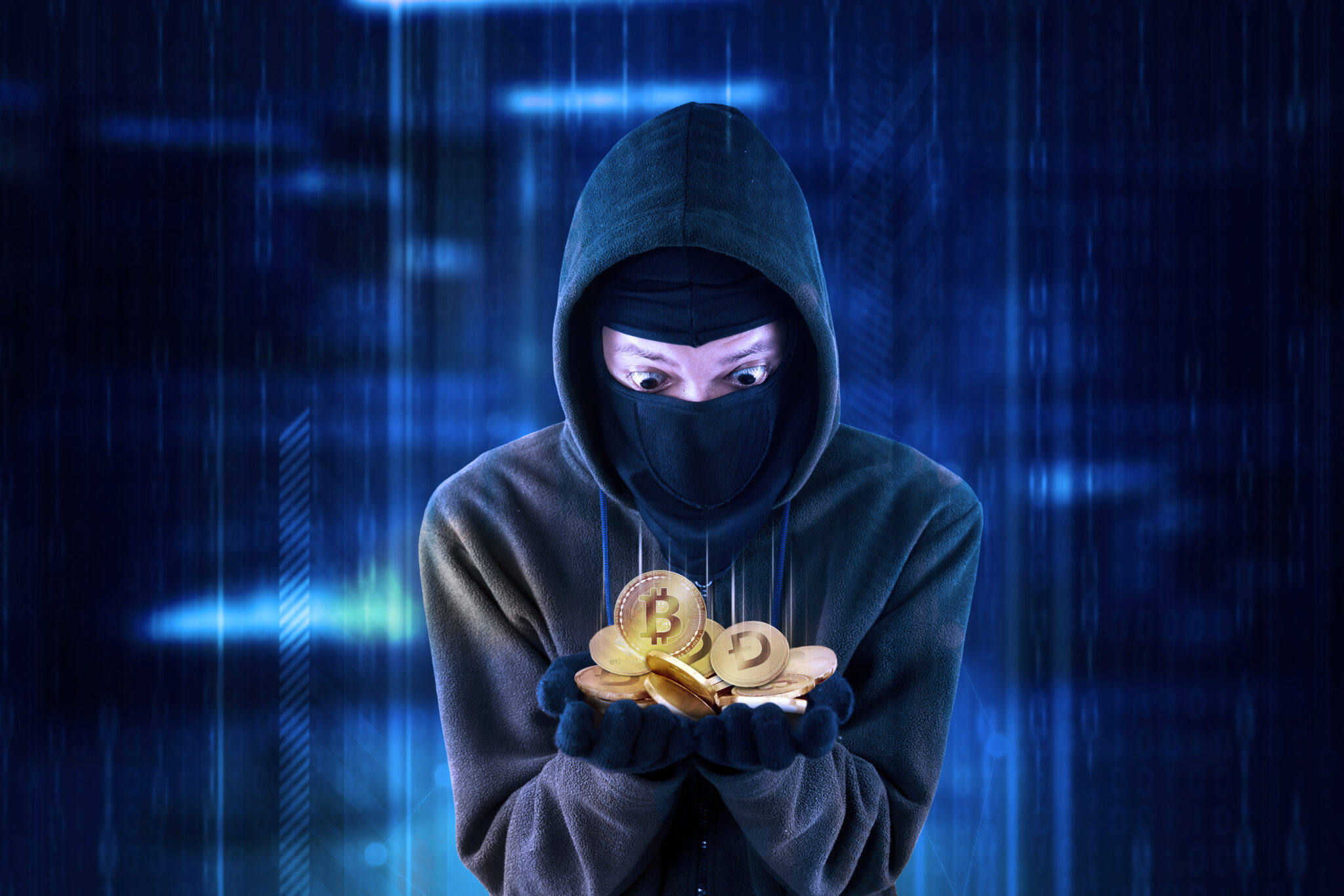 Hooded hacker looks shocked while getting cryptocurrency coins and standing with virtual screen background