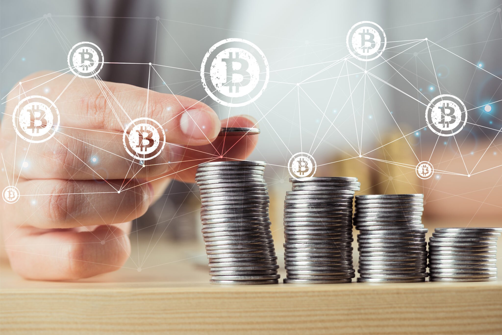 person stacking bitcoins