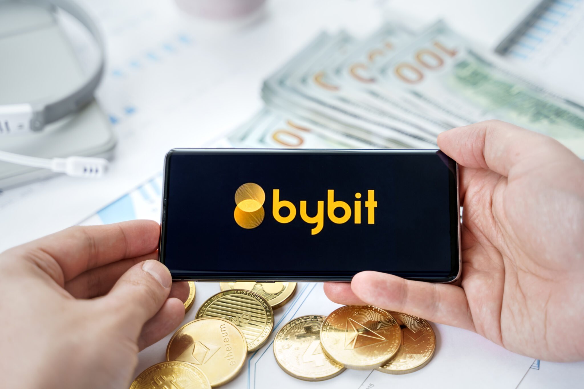 Russia Moscow 20.05.2021 Bybit logo in mobile phone.Cryptocurrency decentralized exchange DEX.Trading blockchain platform.Swap,buy,sell crypto token,digital coin Bitcoin,Ethereum.Business,investing.
