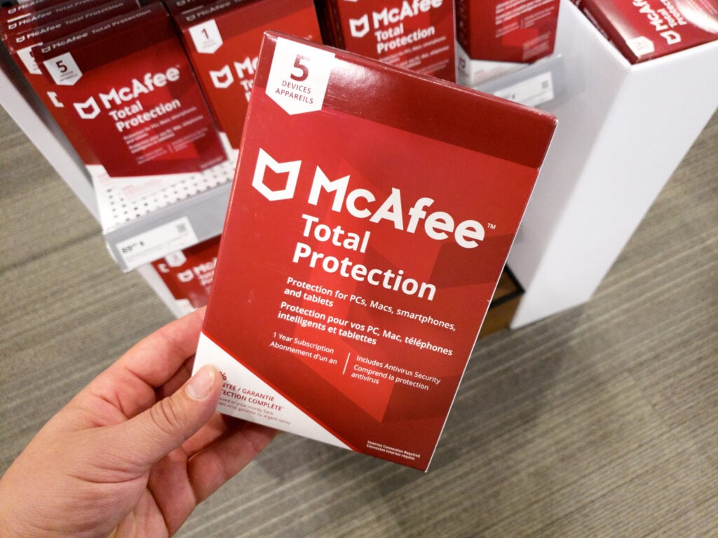 A hand holding McAfee Total Protection