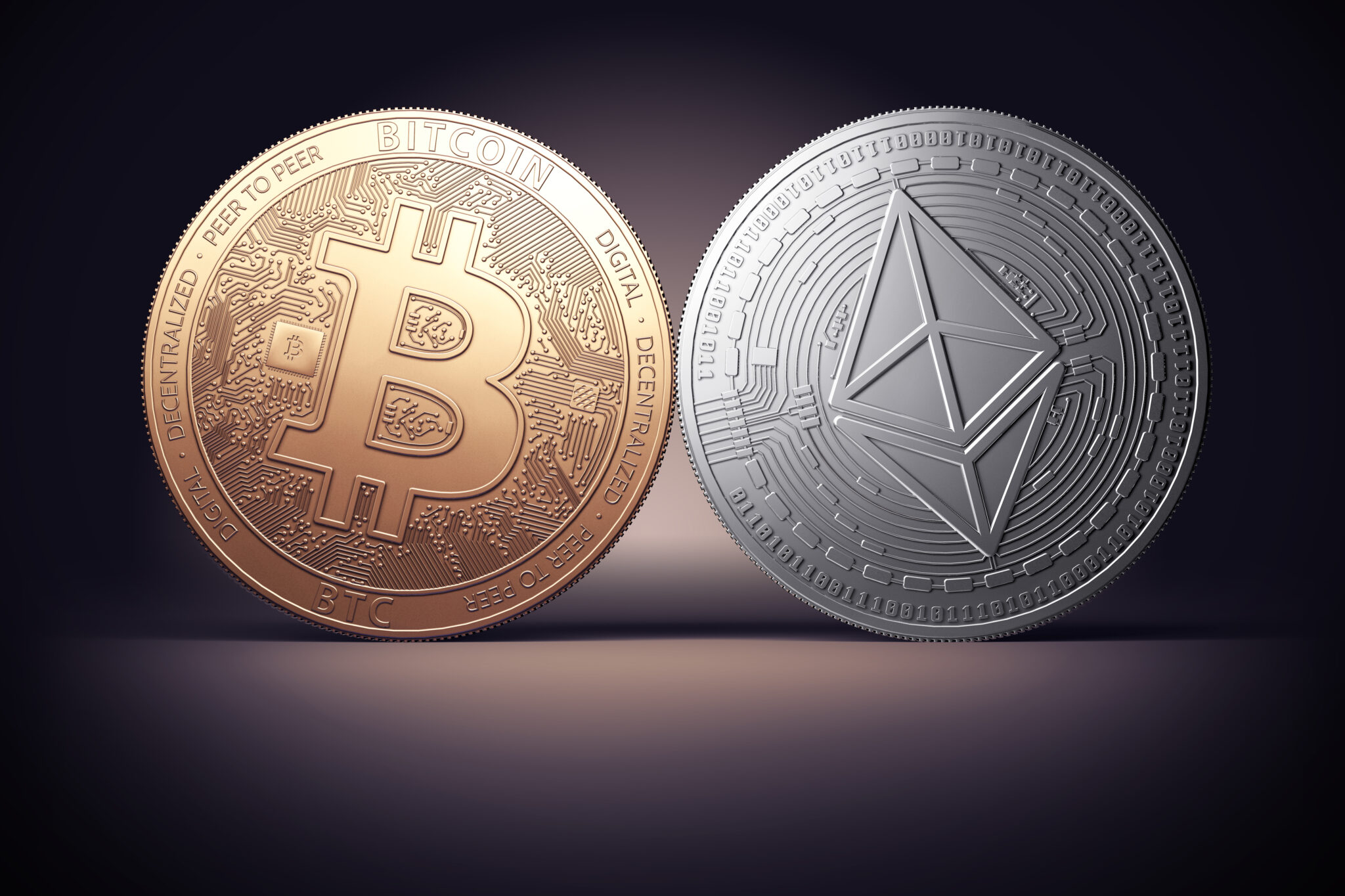 Clash of Bitcoin and Ethereum coins on a gently lit dark background. Competing cryptocurrencies concept.