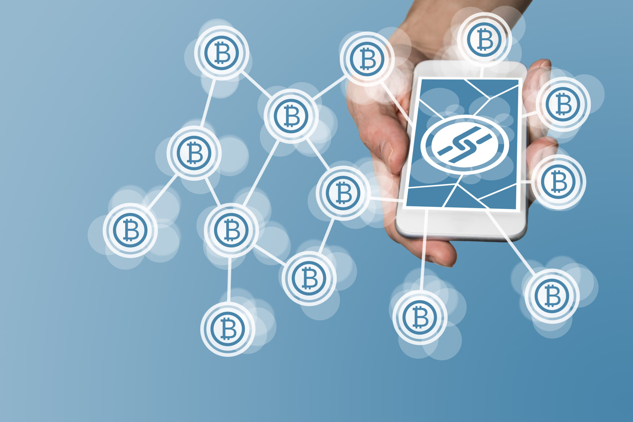 Concept of blockchain and bitcoin with a modern smartphone holding hand as an example for the technology of fin technology