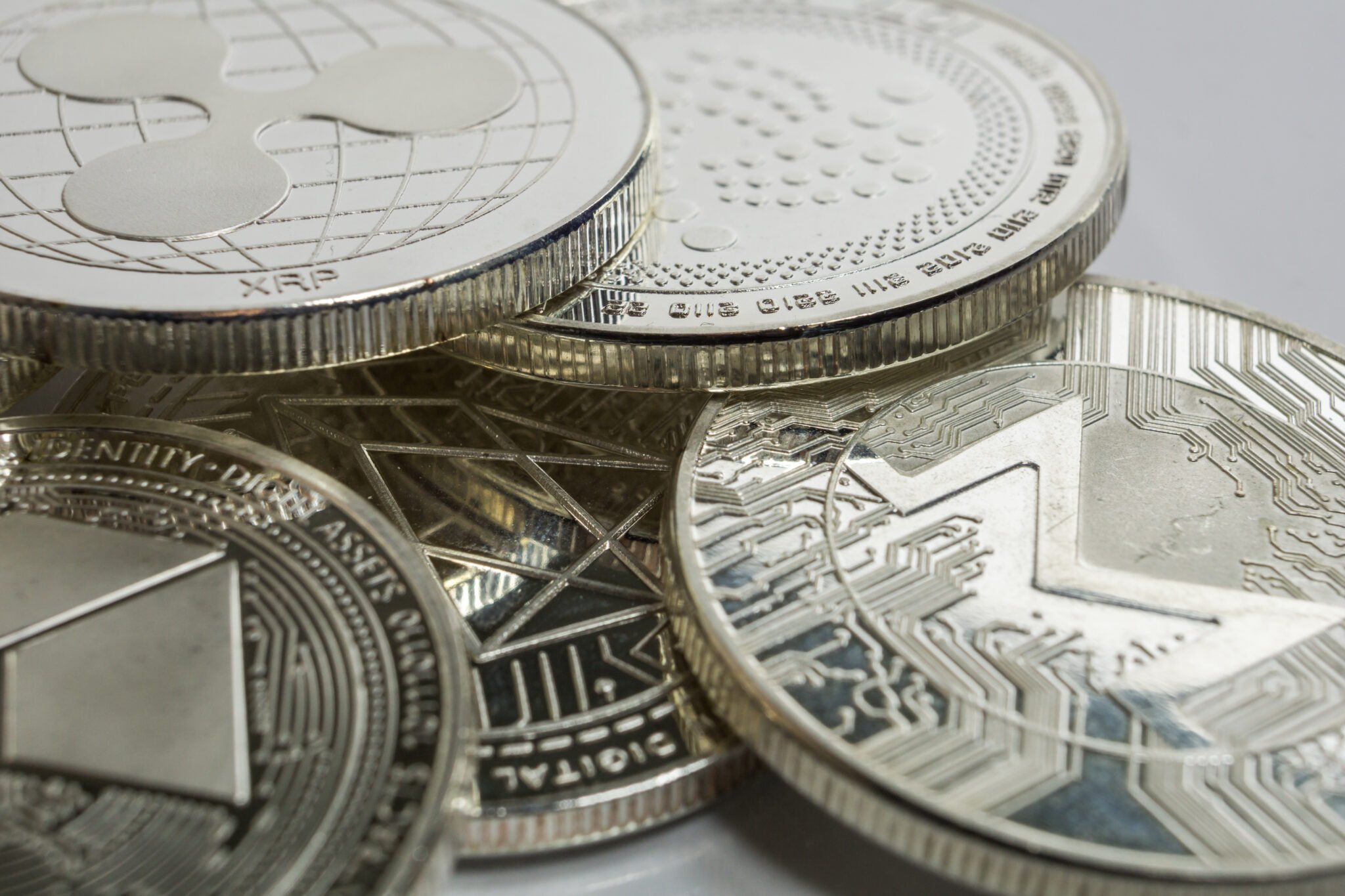 Blockchain cryptocurrency physical coins surrounded with variety of other crypto altcoins.