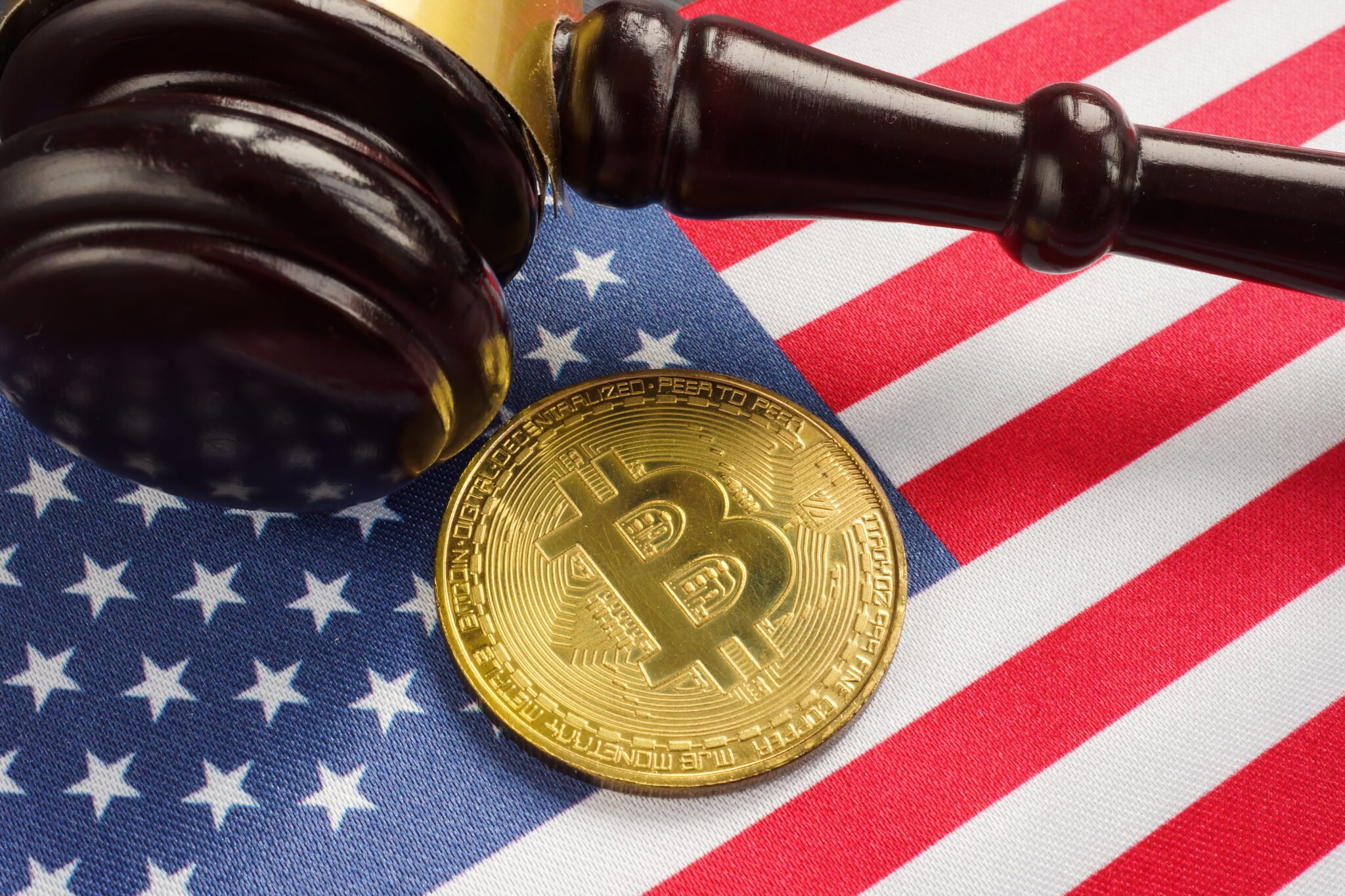 Crypto regulation law in USA. Gavel, flag and Bitcoin.