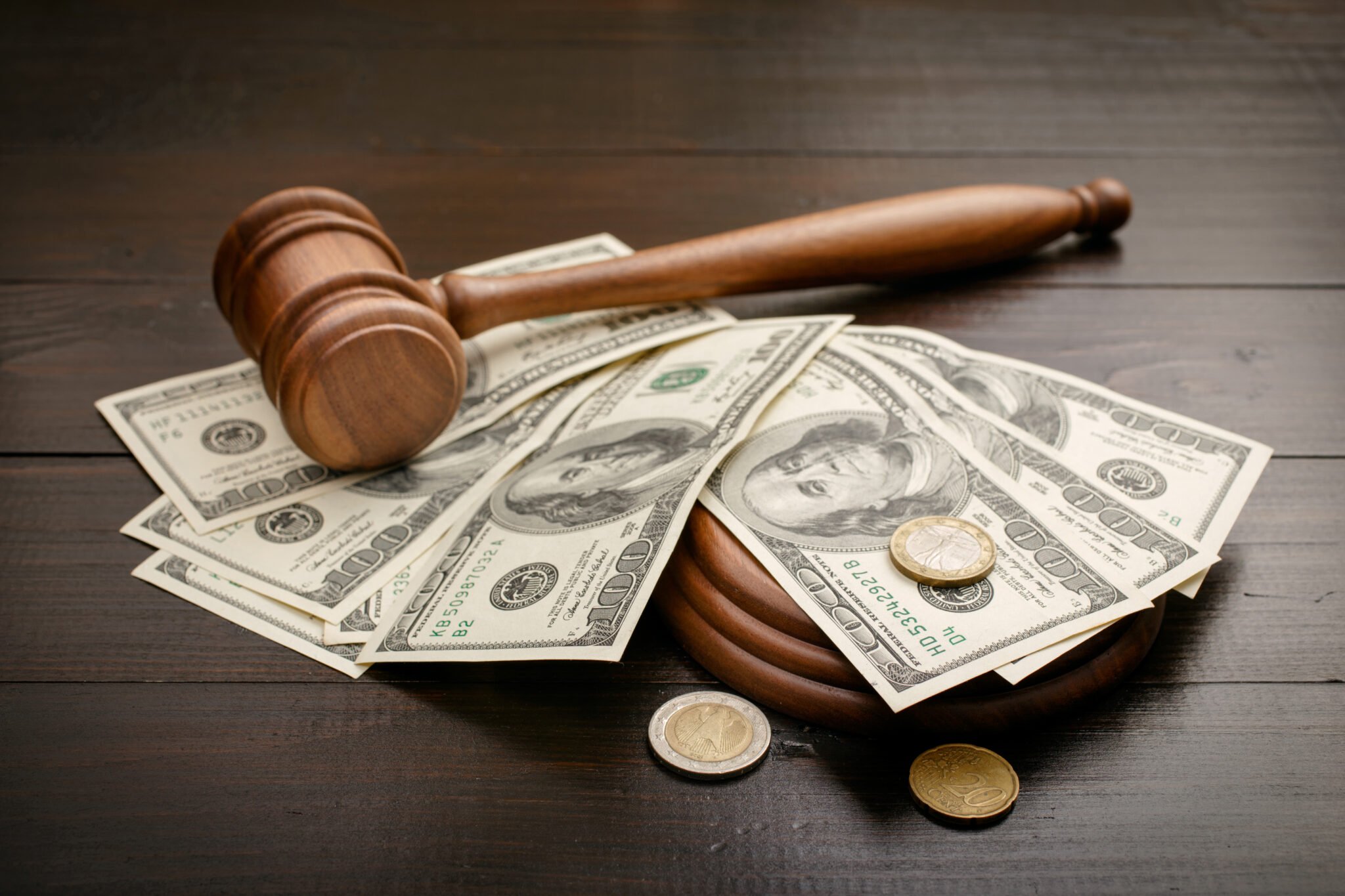 Gavel with dollars and cents