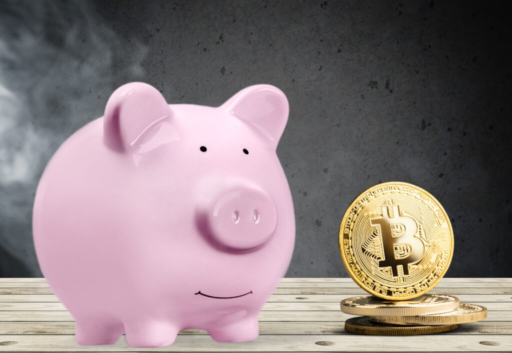 The concept of using digital cryptocurrency for savings. Coin and a piggy bank as a saving