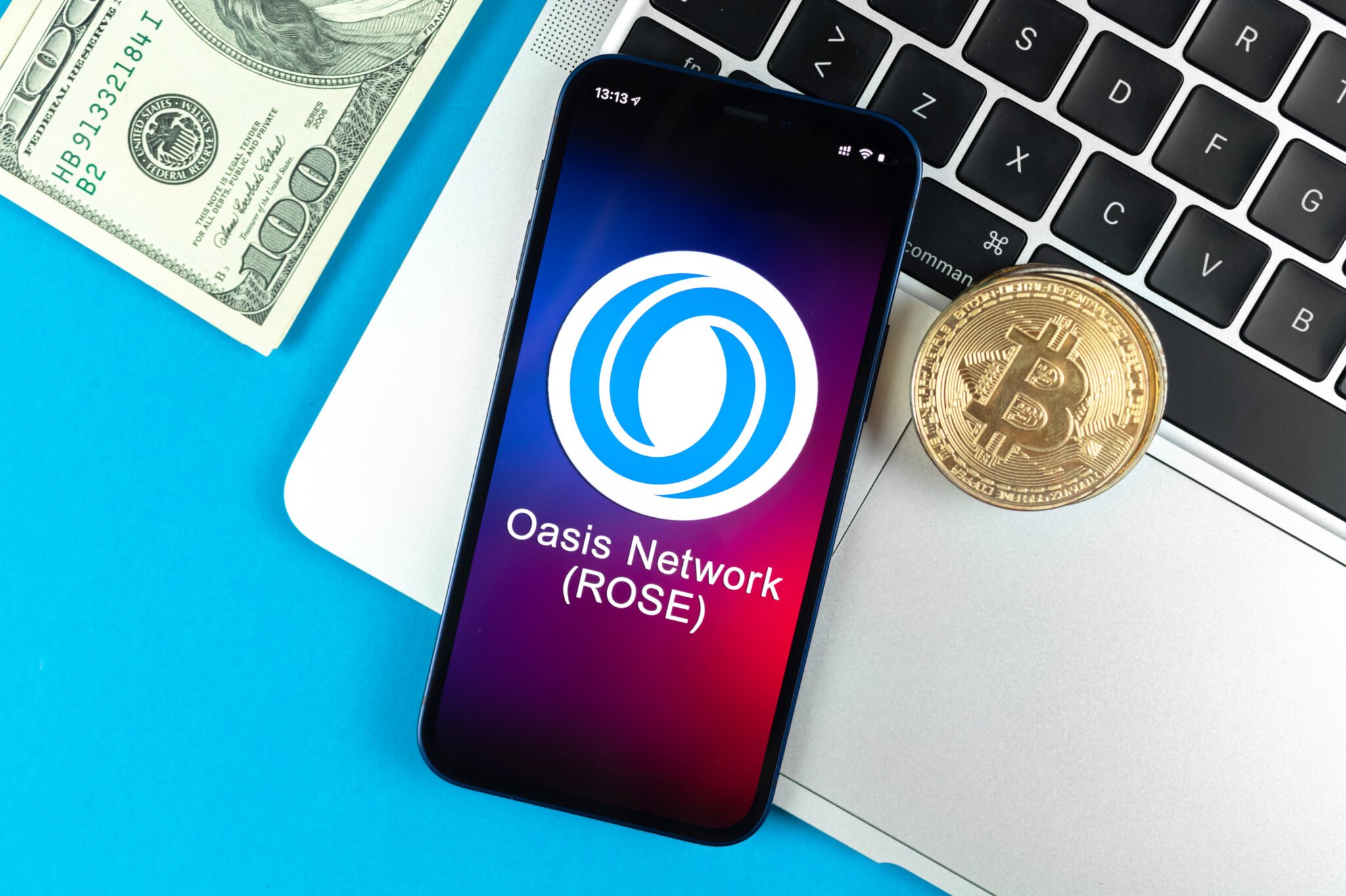 Kharkov, Ukraine - January 31, 2022: Oasis Network ROSE currency symbol.  Trade with banking including cryptocurrency, digital and virtual money, mobile phone concept.  Business workplace, table with laptop