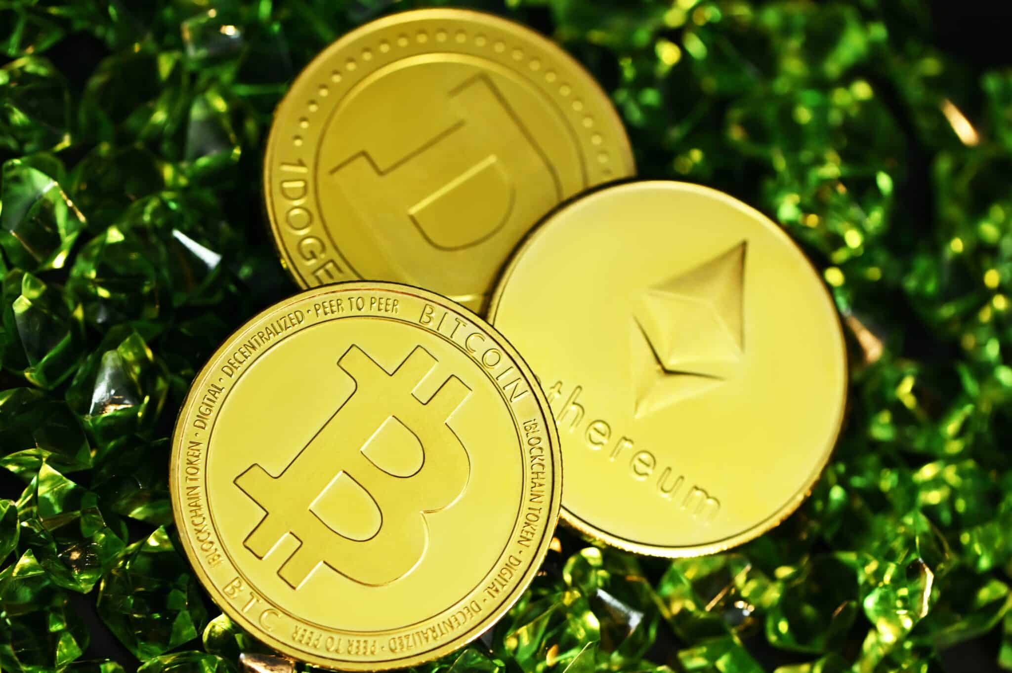 A bitcoin and other crypto coins on top of the green crystals