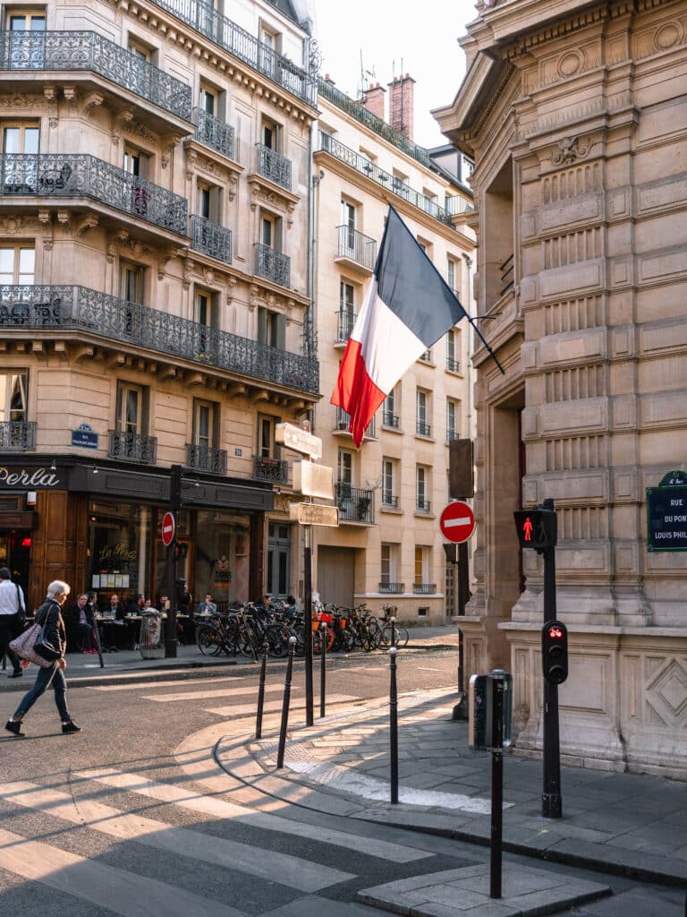 France flag on gray concrete building near road