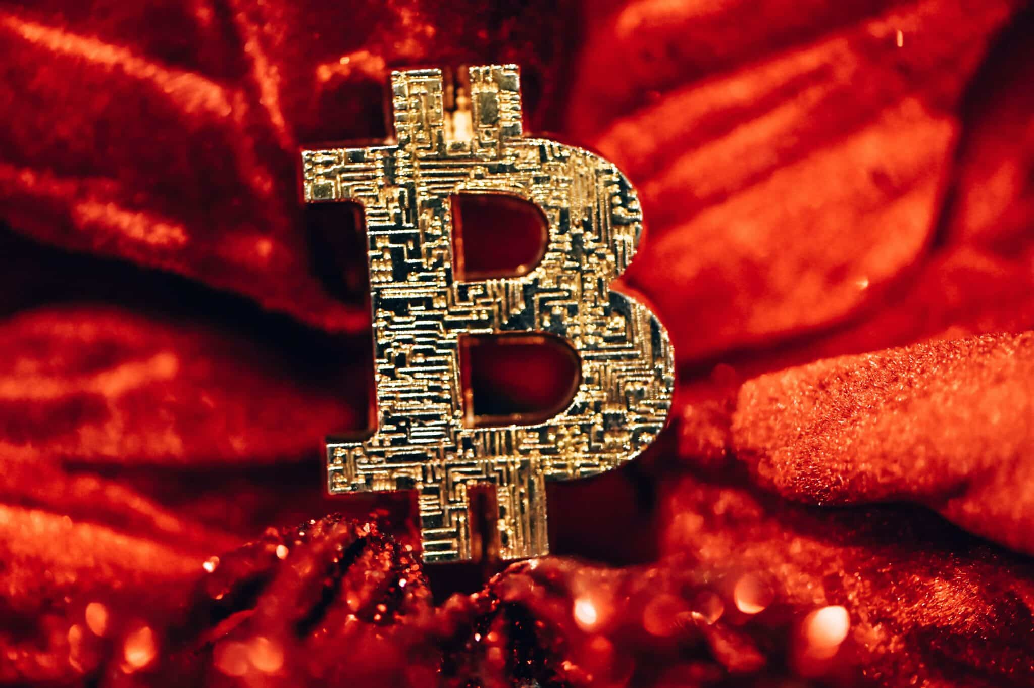 A Bitcoin symbol on a red velvet background