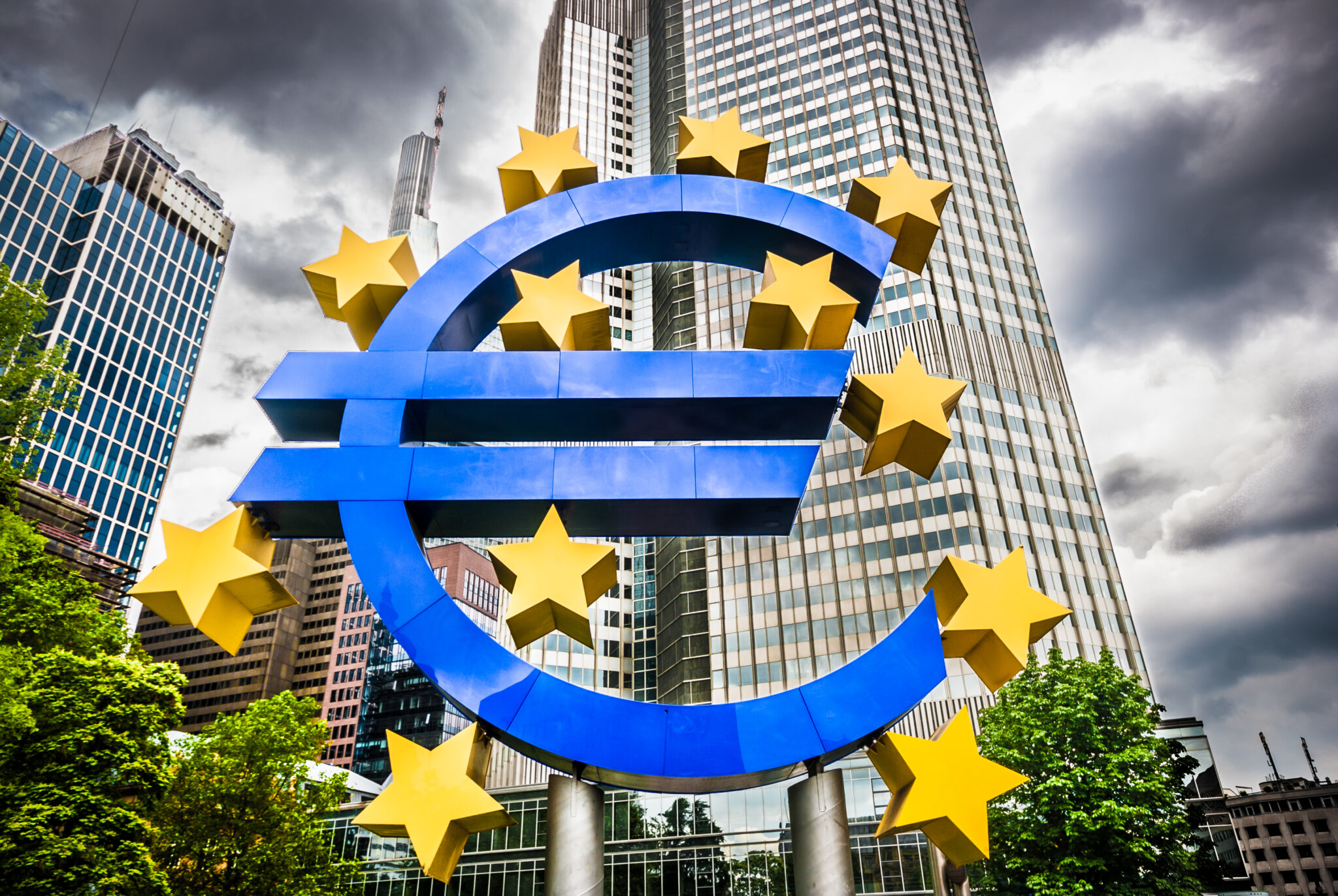 Euro sign with dark clouds at European Central Bank headquarters in Frankfurt, Germany