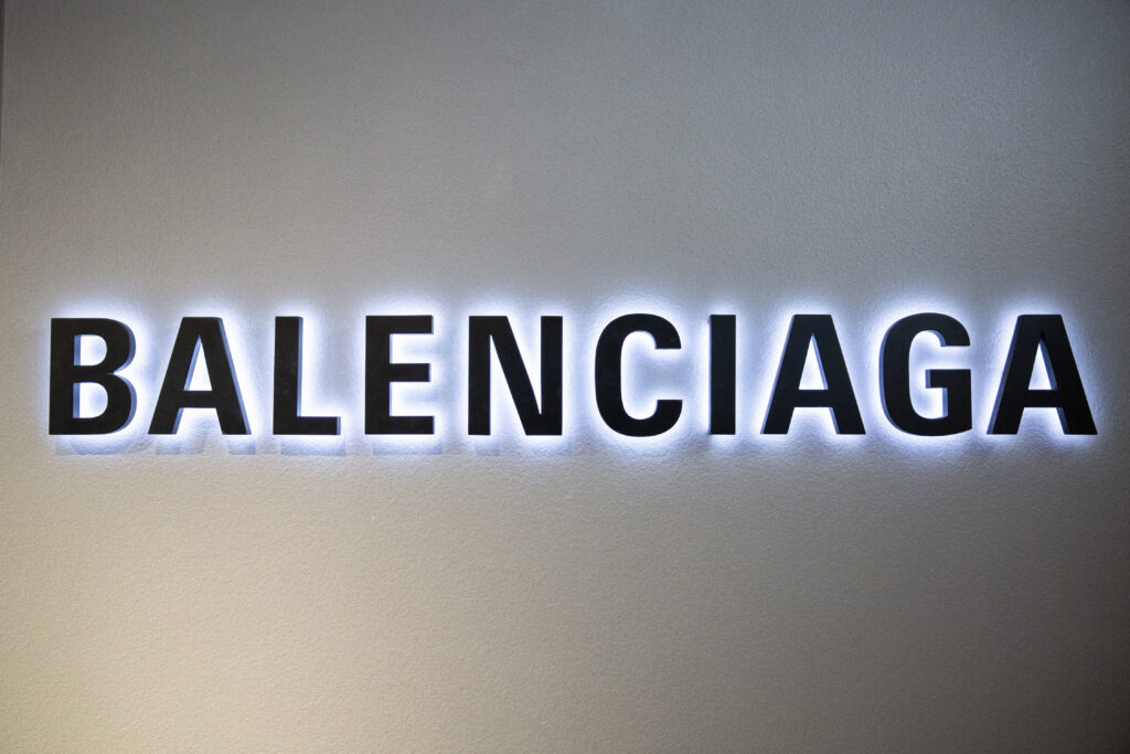 LONDON, UK - FEBRUARY 20, 2020: Balenciaga backlit logo in Harrods shopping mall. Balenciaga is a luxury fashion house founded in Spain by Cristobal Balenciaga.