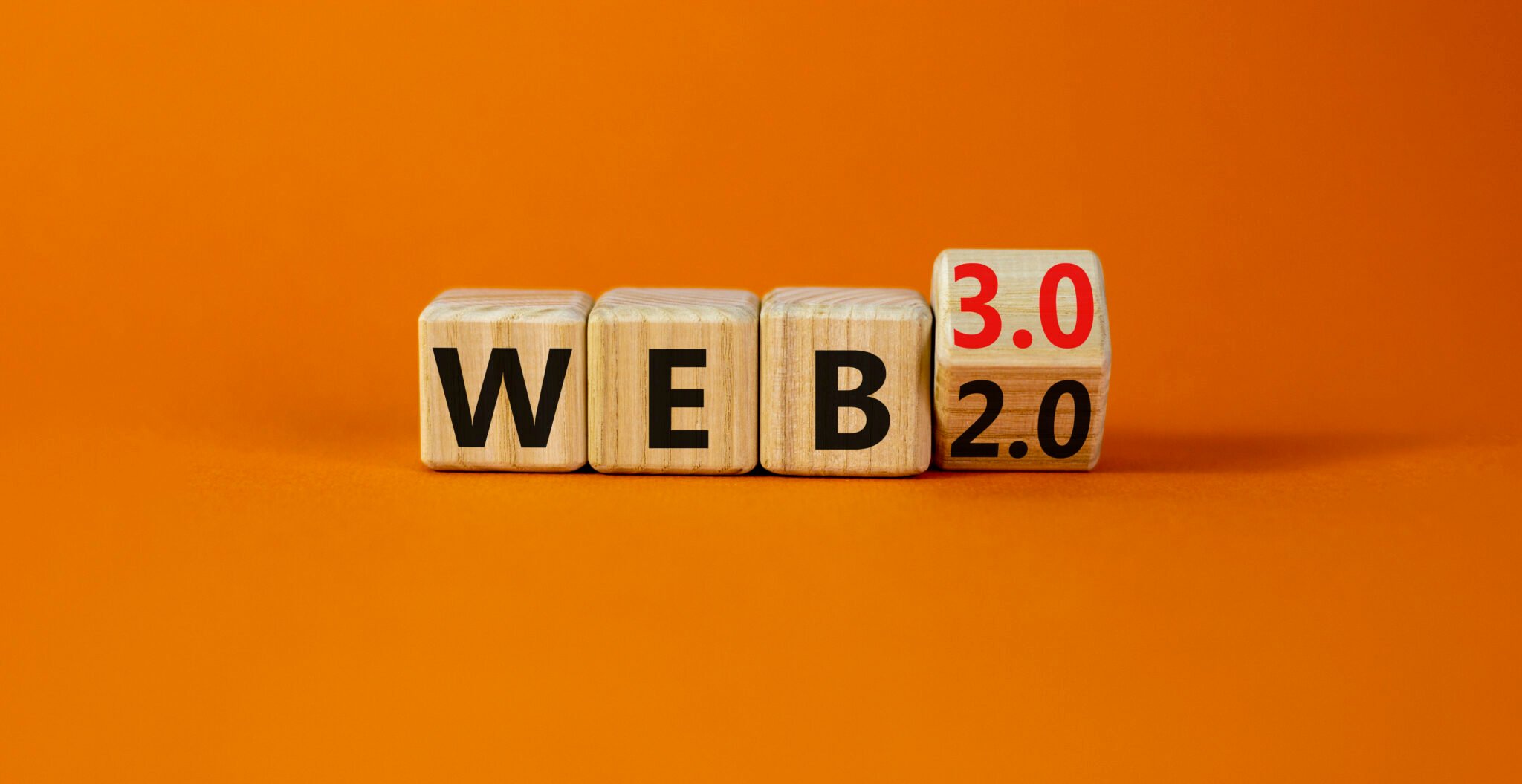 Web2 or Web3 symbol. Turned a wooden cube and changed words WEB 2.0 to WEB 3.0. Beautiful orange table, orange background, copy space. Business, technology and WEB 2.0 or 3.0 concept.