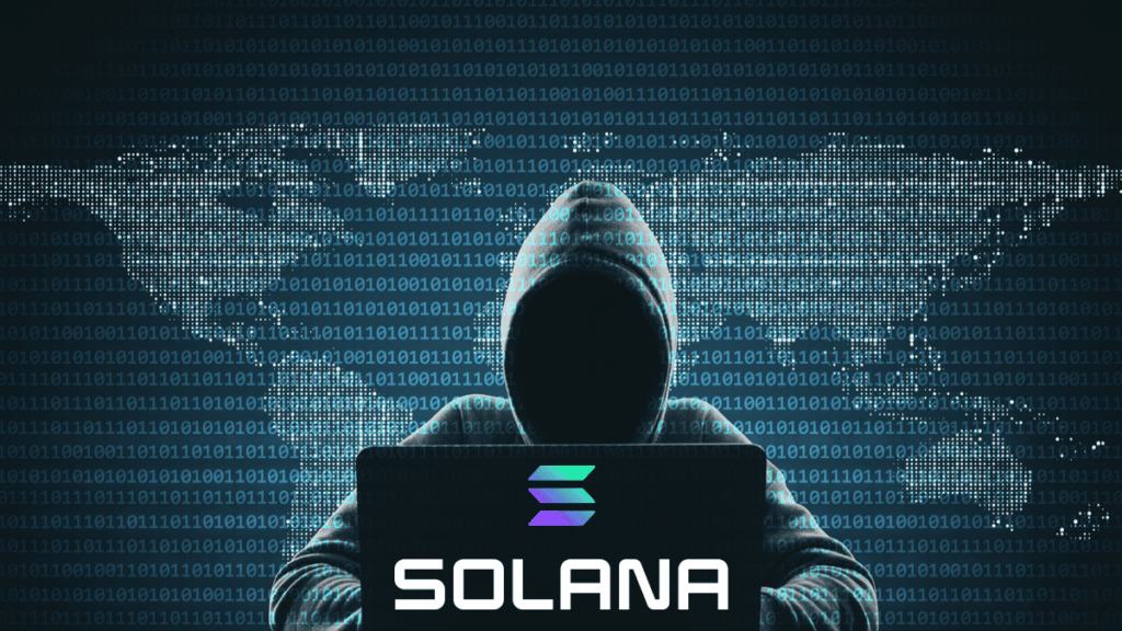 Homme portant une capuche, le visage caché, assis face à un ordinateur Solana