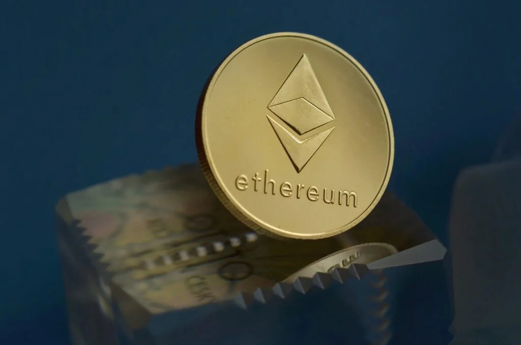 Ether coin (ETH) on blue background.