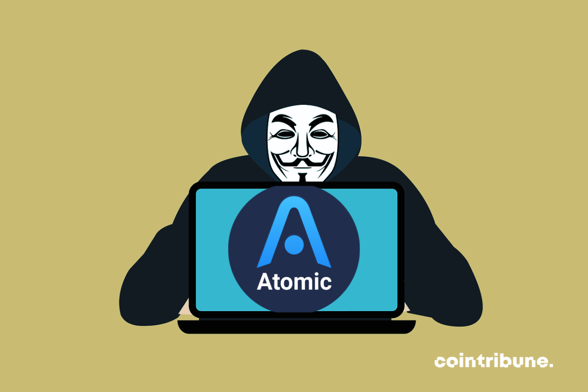 Un hacker présentant un ecran sur lequel figure le logo de Atomic Wallet
