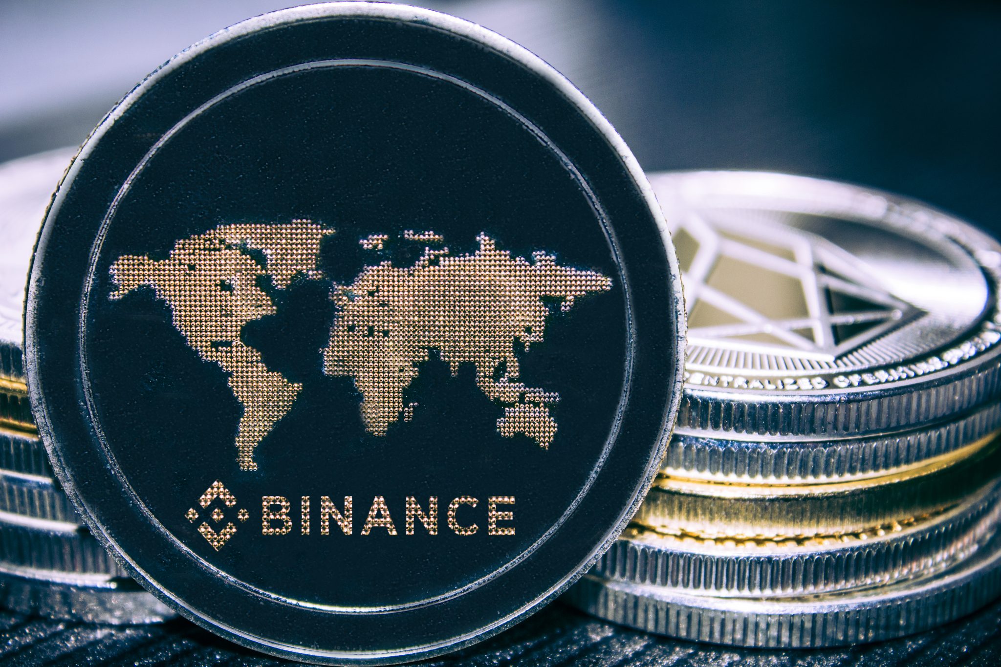 Coin cryptocurrency BNB on the background of a stack of coins.