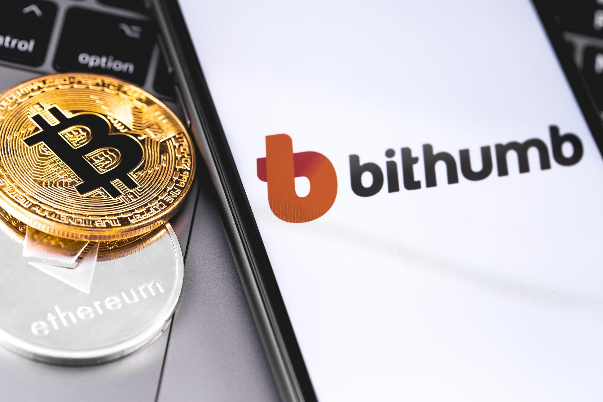 bitcoins, Bithumb logo of crypto-exchange on the screen smartpho