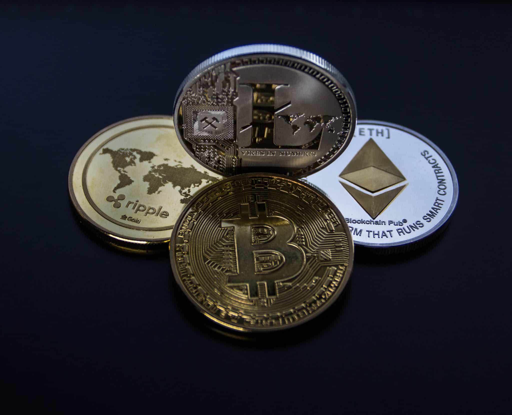 Four assorted cryptocurrency coins