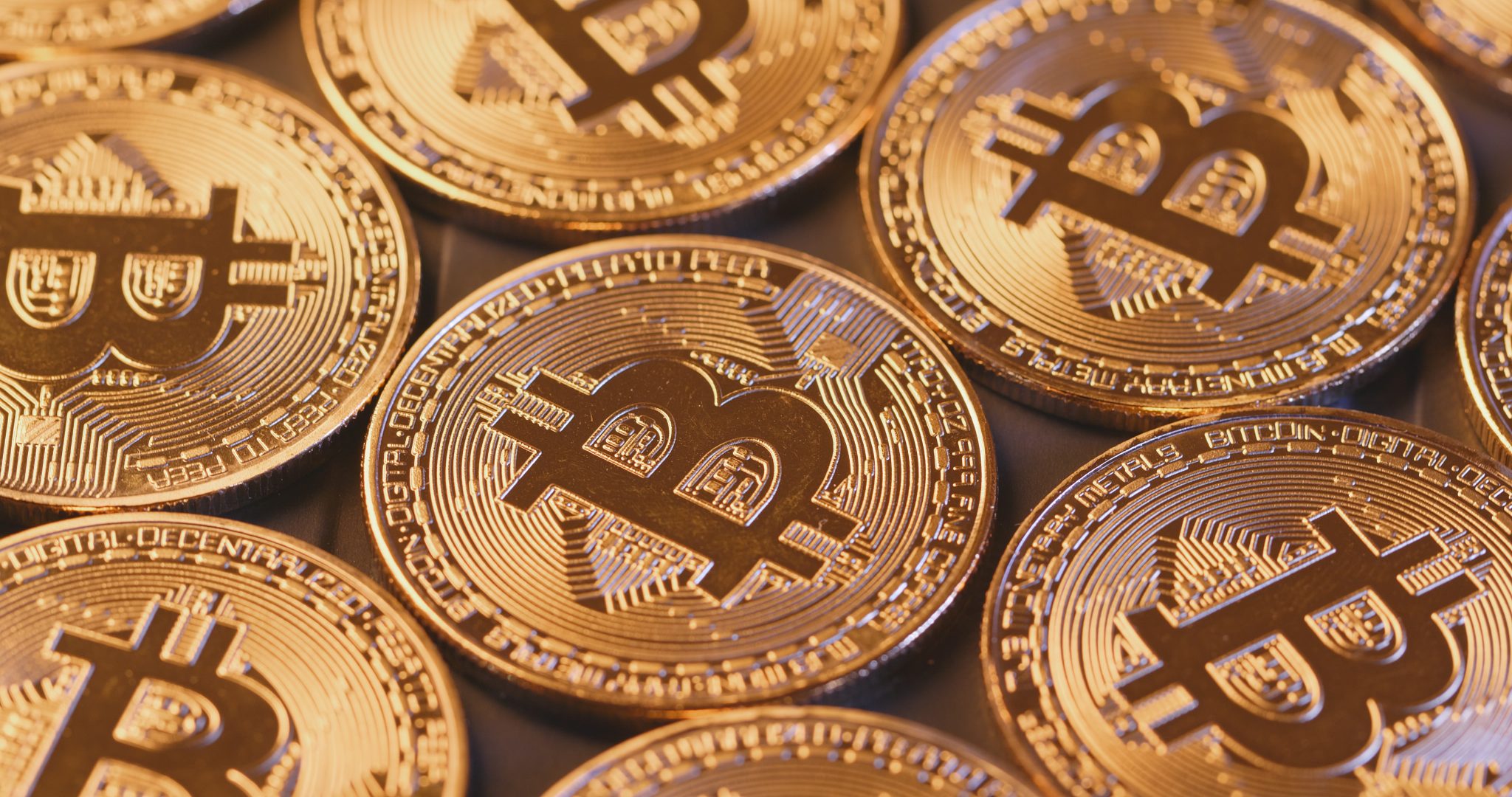 Golden Bitcoins in pile close up