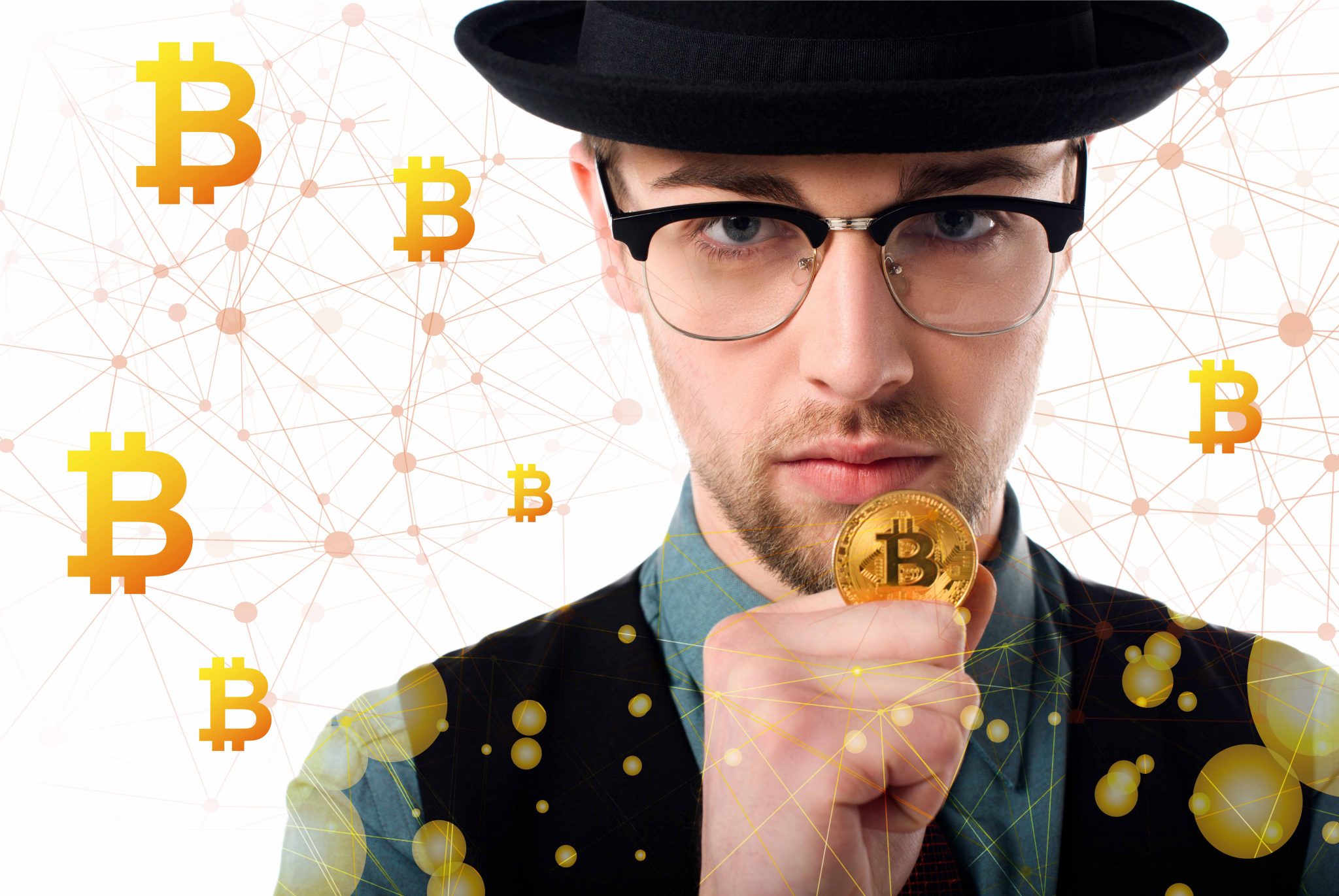 Portrait of man in eyeglasses and hat holding golden bitcoin on white