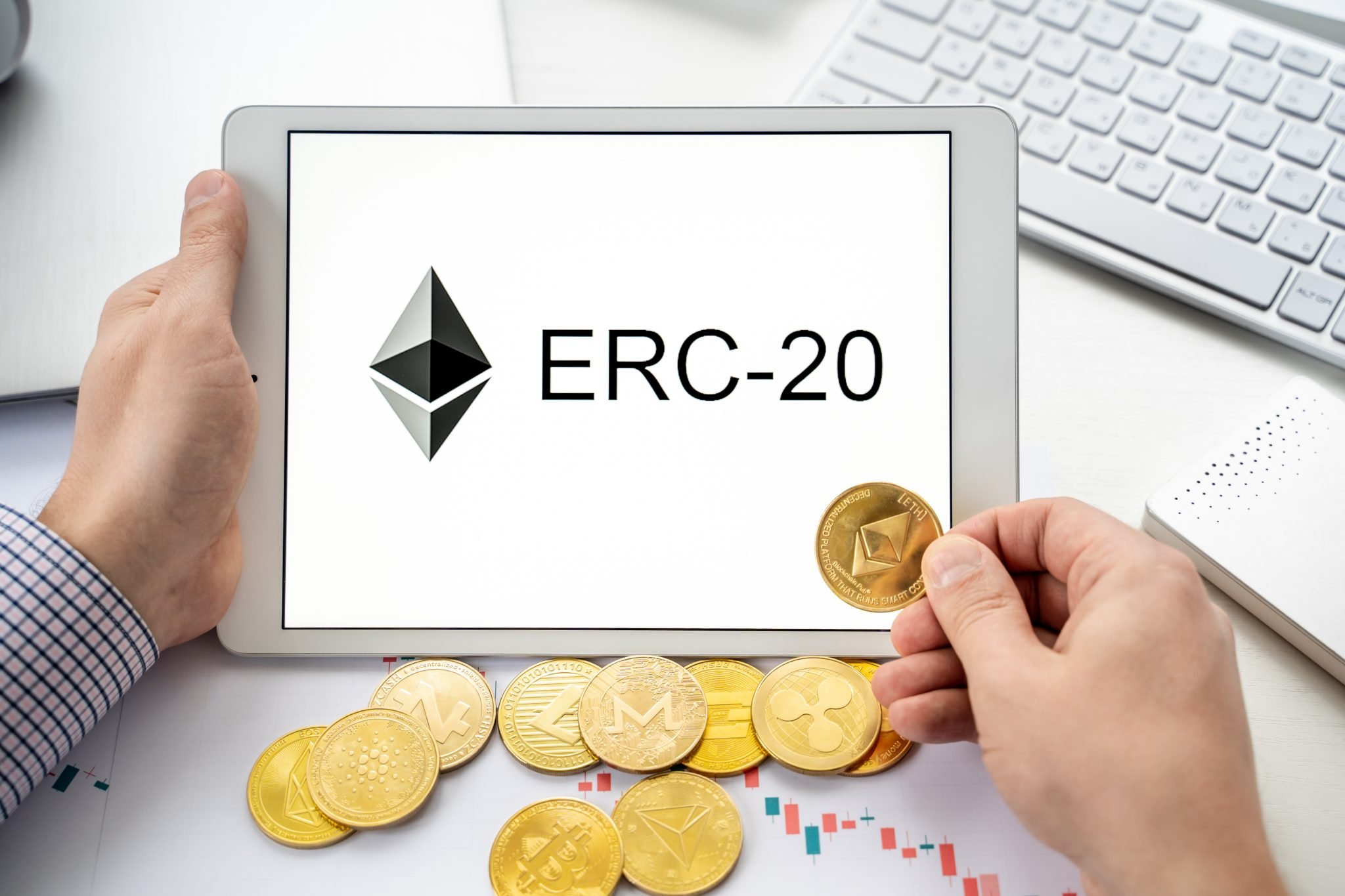 Russia Moscow 06.05.2021.Businessman holding tablet with logo of ERC-20 official protocol of Ethereum ETH network. Standard for creating tokens on Ethereum blockchain.