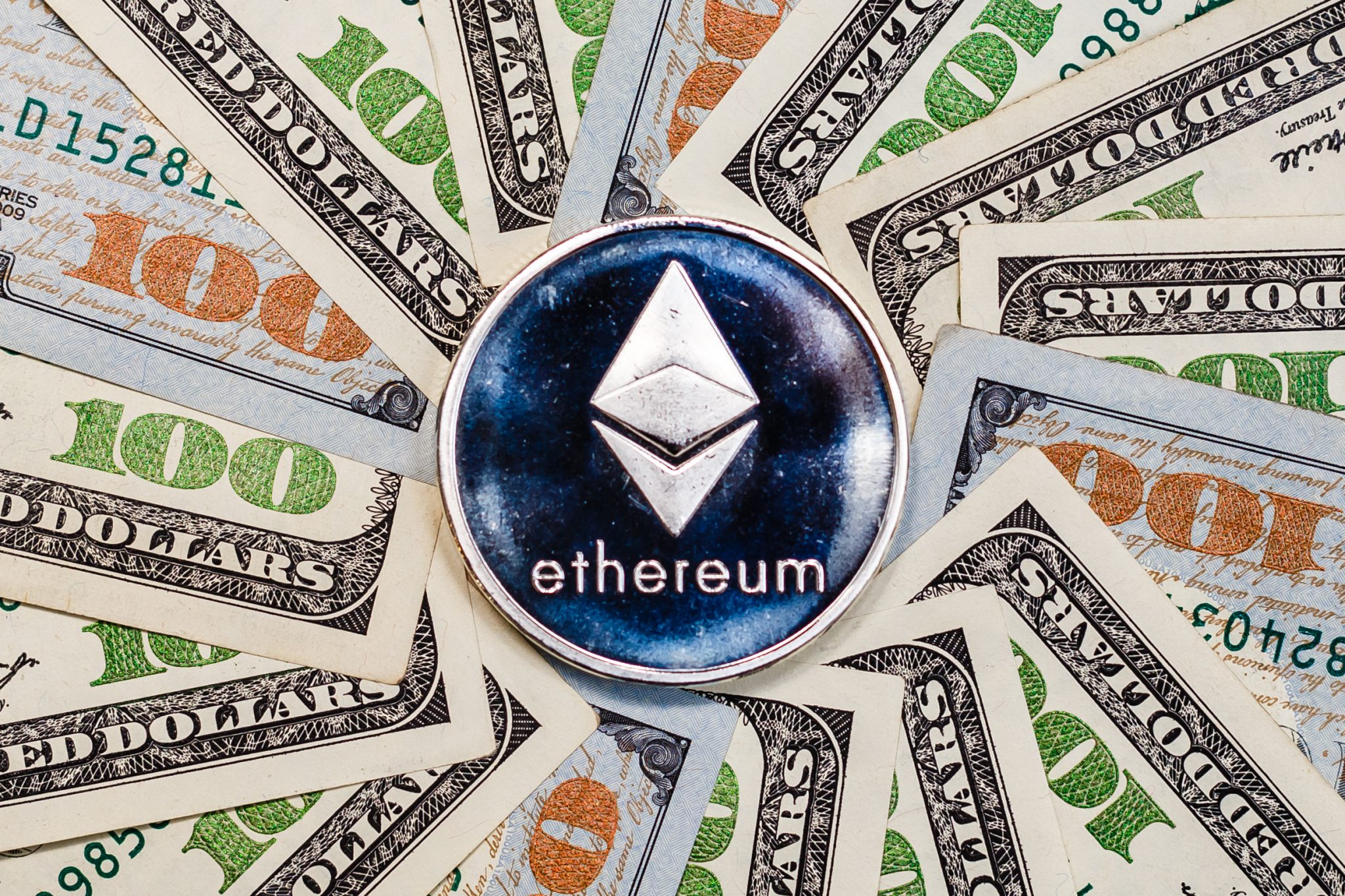Ethereum crypto currency on dollar banknotes