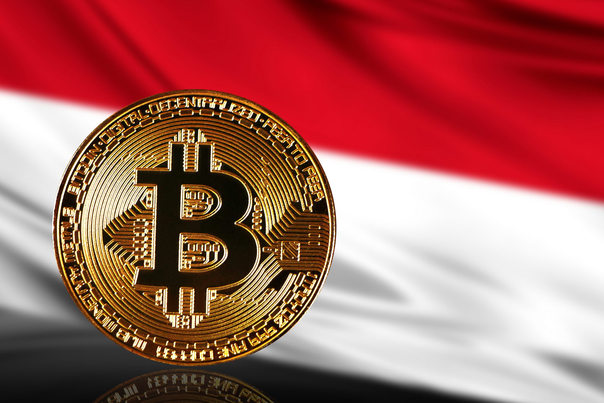 gold coin bitcoin on a background of a flag Indonesia