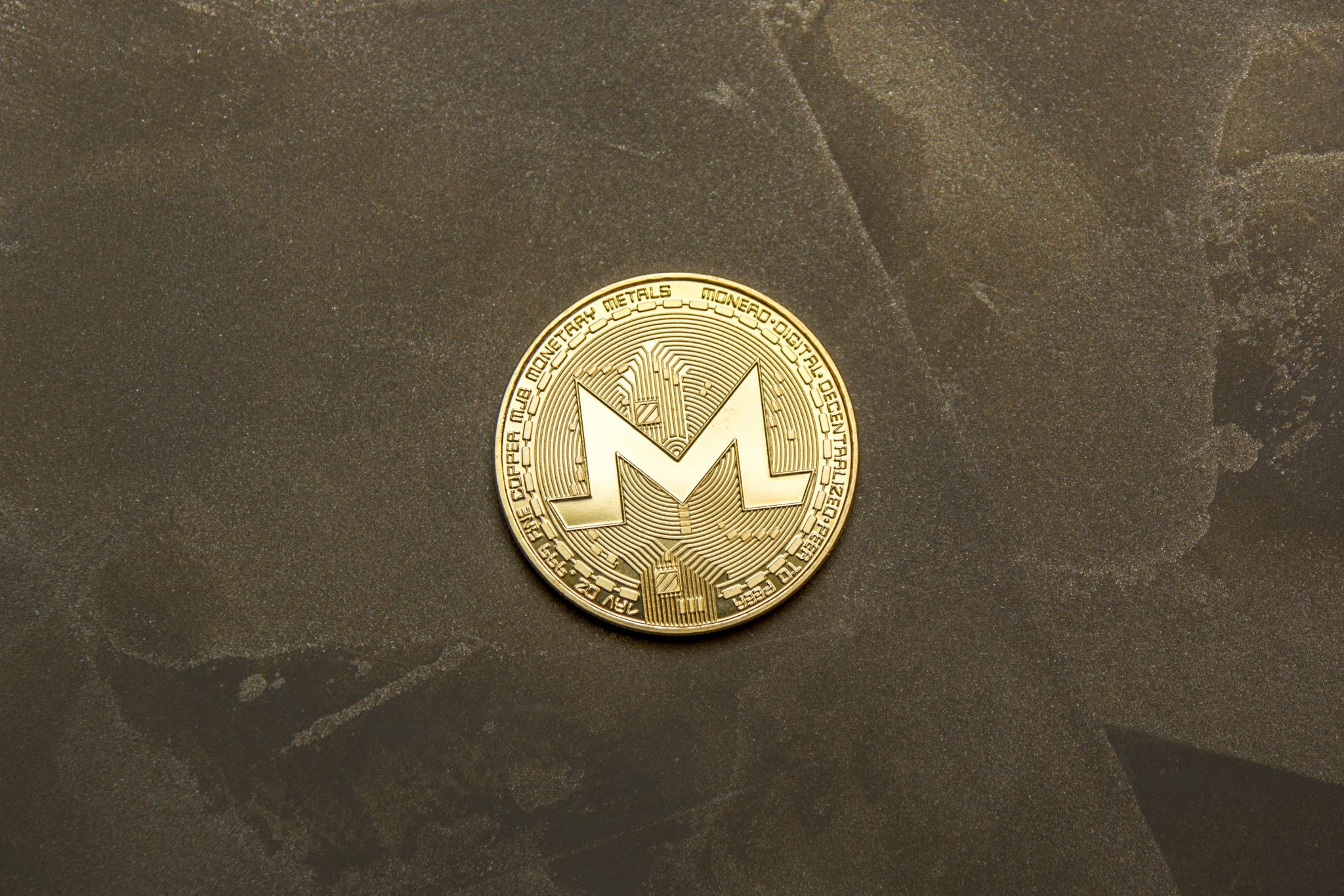 golden monero on background maded from decorative plaster